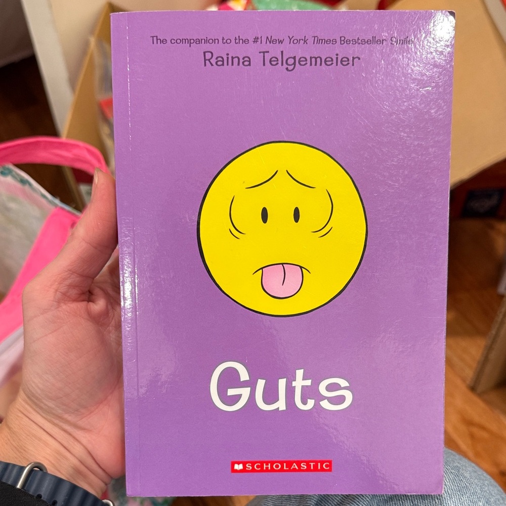 Scholastic Purple Book with Yellow Emoji